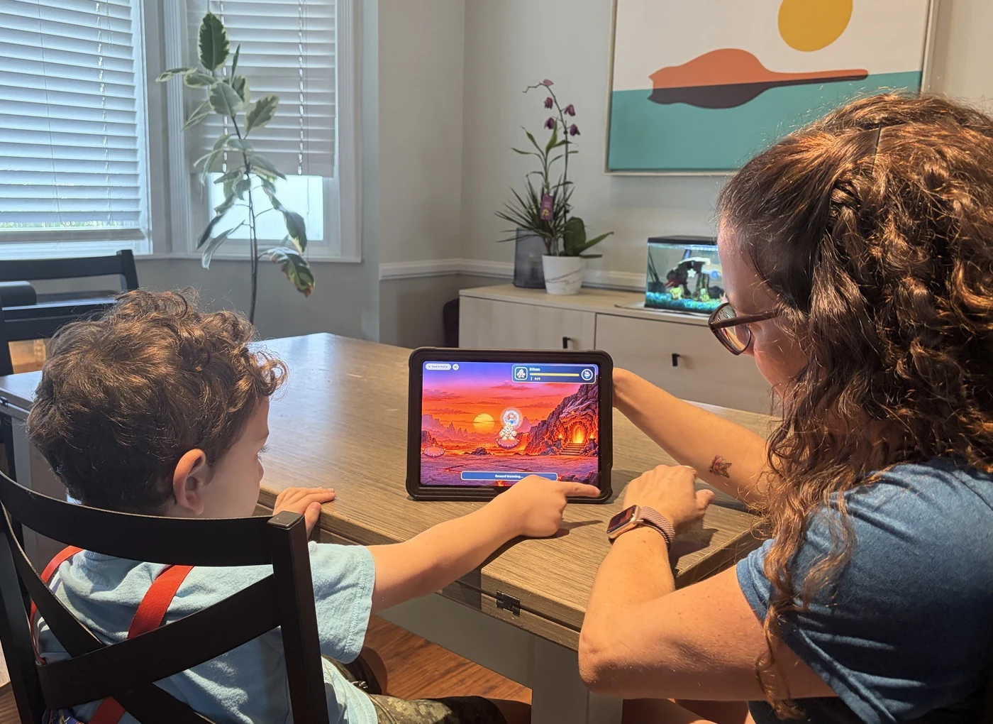 A parent and child using Behavior World together on a tablet